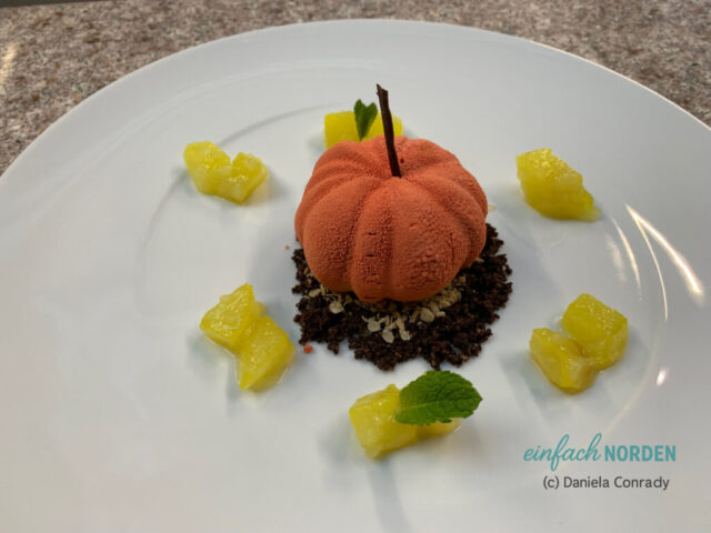 Schokoladiges Dessert in Form eines Kürbis mit Deko